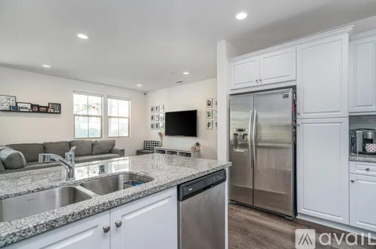 A kitchen with granite countertops and stainless steel appliances.