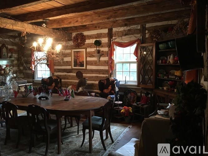 A family is sitting around a wooden table in a cozy room.