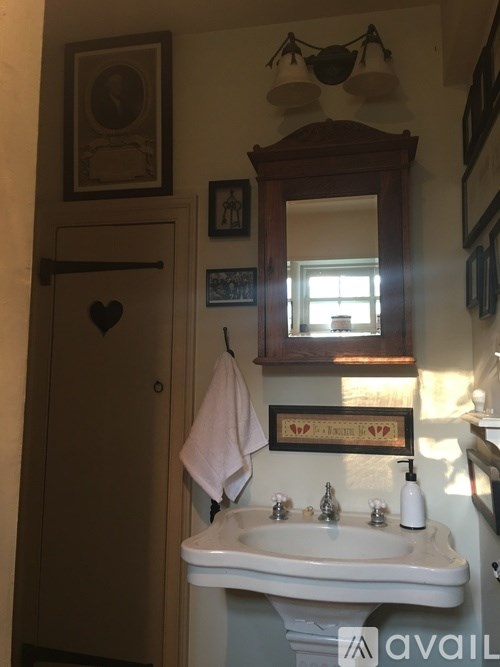 A bathroom with a white sink and a mirror above it.