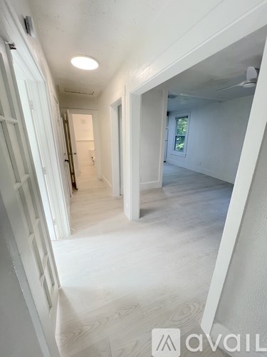 A room with a ceiling fan and a window.