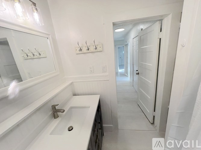 A kitchen with white appliances and cabinets.