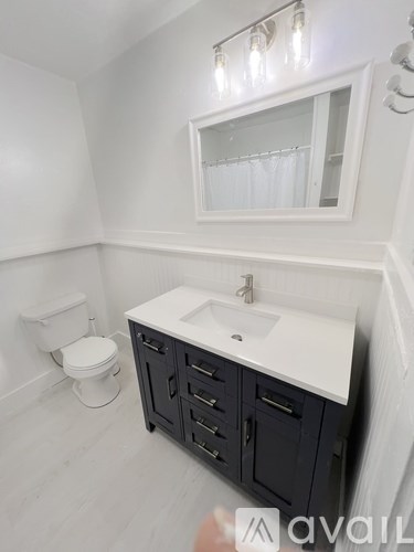 A kitchen with white appliances and cabinets.