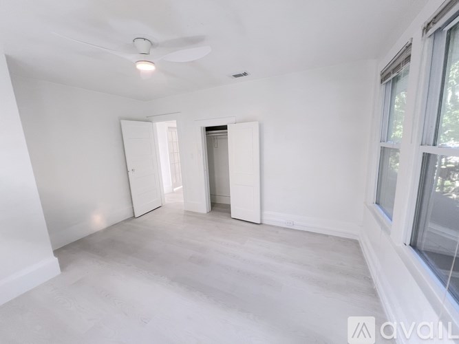 A kitchen with white cabinets and appliances.