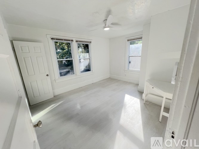 A kitchen with white appliances and cabinets.