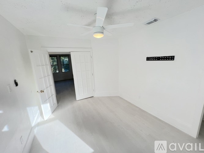 A kitchen with white cabinets and a wooden table.