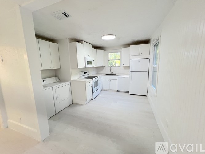 A bathroom with a sink, mirror, and light switches.