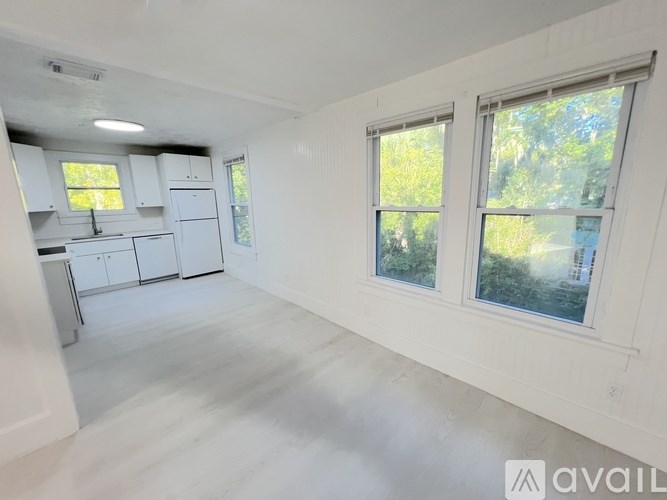 A room with a white ceiling fan and a white chair.