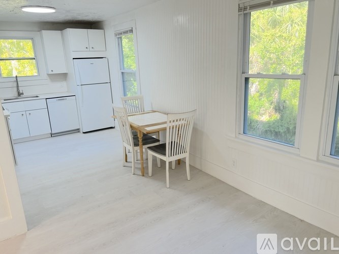 A room with a ceiling fan and two doors.