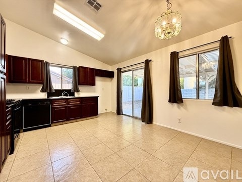 A kitchen with brown cabinets and a black stove top oven.