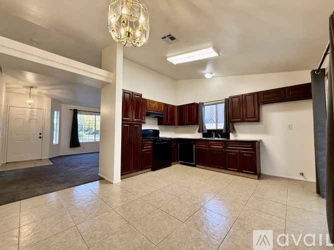 A spacious kitchen with dark wood cabinets and a central island.