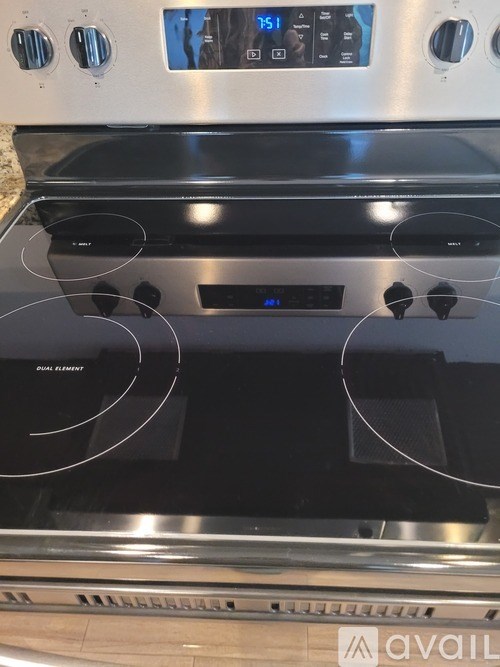 A stainless steel oven with a digital display and control panel.