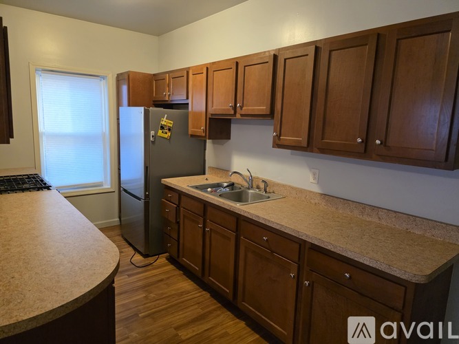 A kitchen with wooden cabinets and a granite countertop.