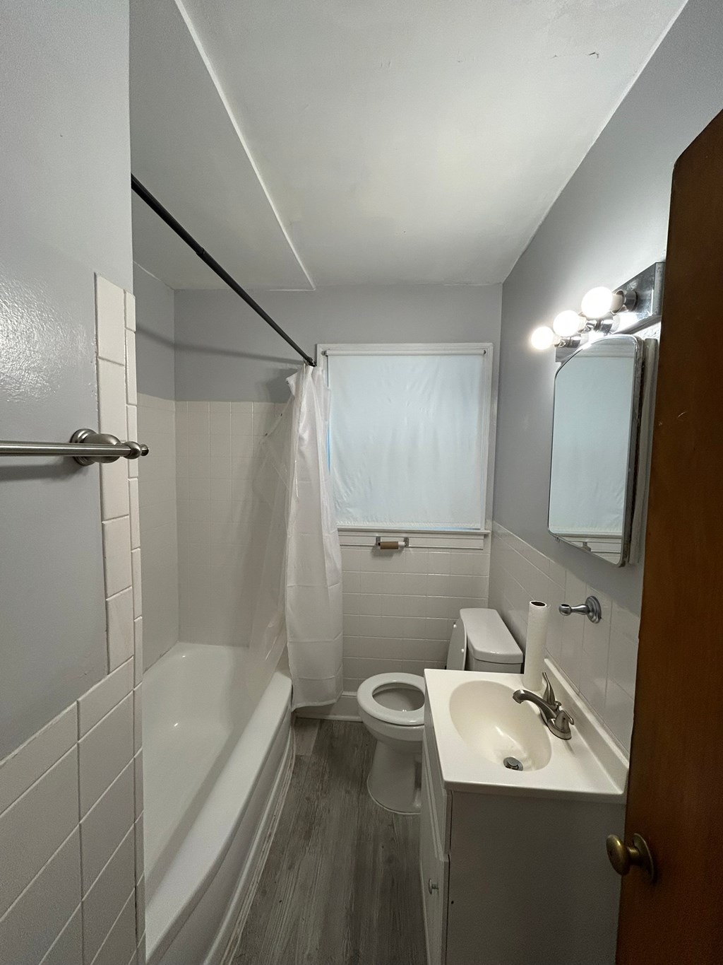 A bathroom with a toilet, sink, and shower.