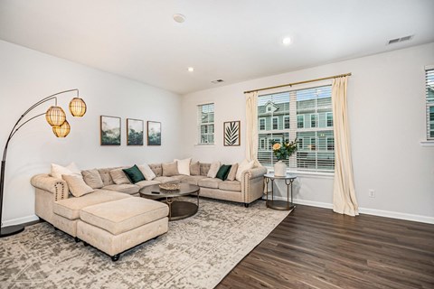 A living room with a large couch and a coffee table.