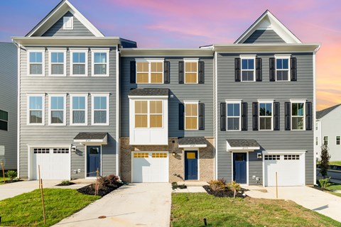 A modern two-story house with a garage on the ground floor.
