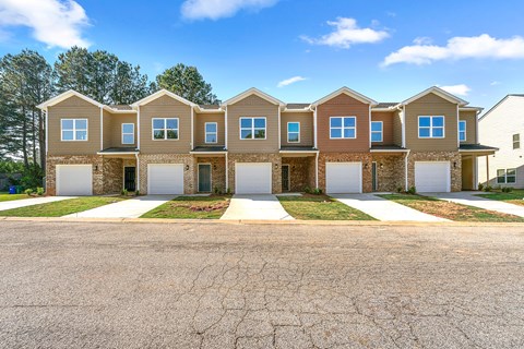 A row of houses with a cracked road in front.