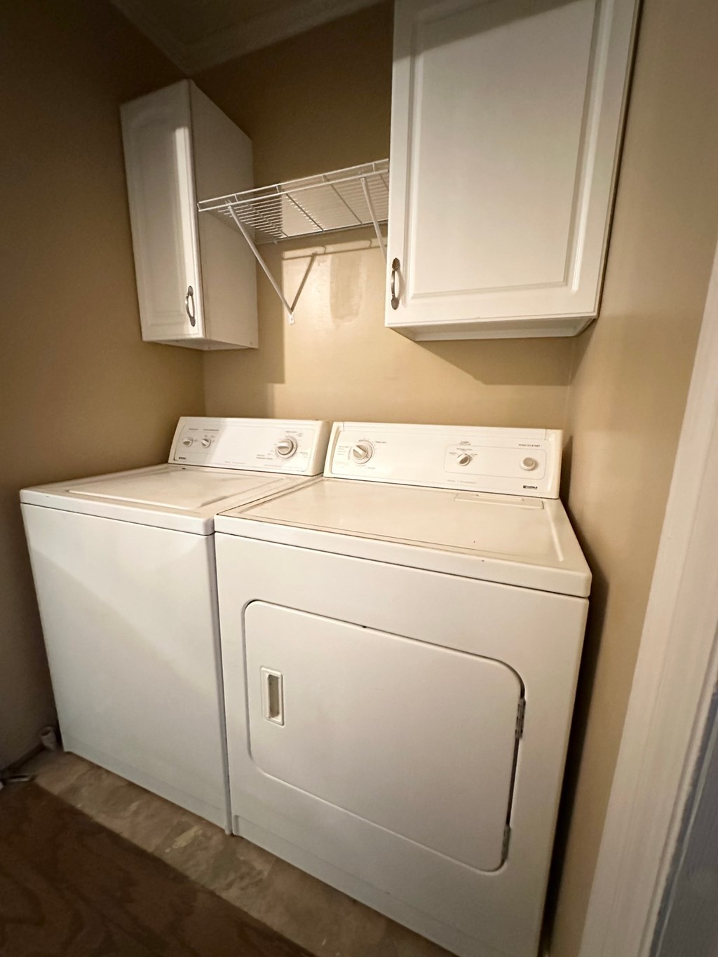 A white washing machine and dryer in a small laundry room.