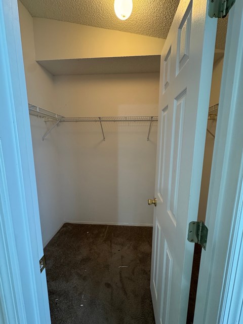 A white door with a green lock on it.