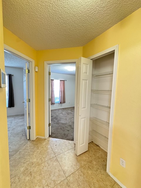 A room with yellow walls and a white door.