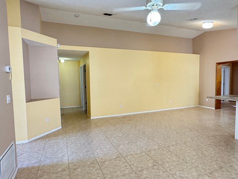 A room with a ceiling fan and a light bulb.
