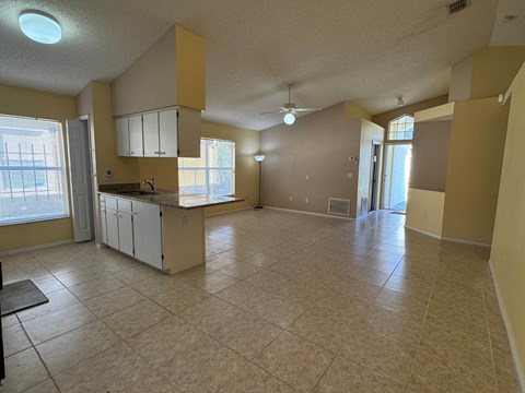A kitchen with a counter and cabinets is shown in this image.