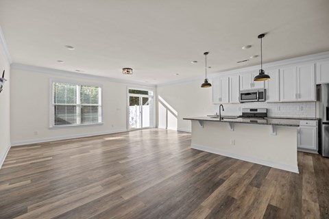 A kitchen with a countertop and cabinets is shown.