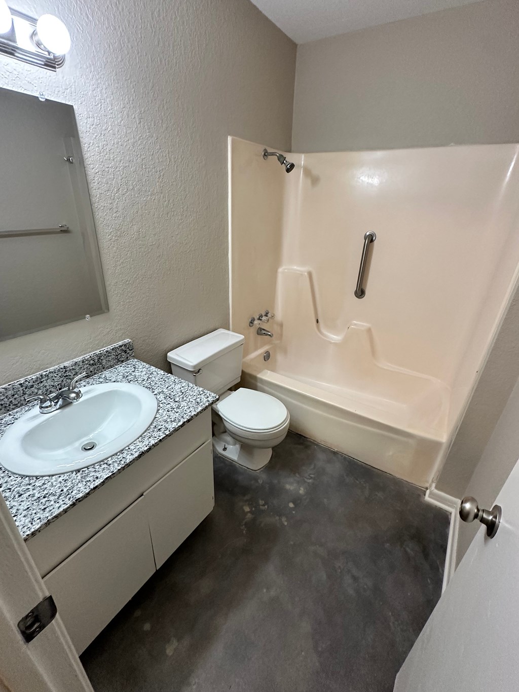 A bathroom with a sink, toilet, and bathtub.