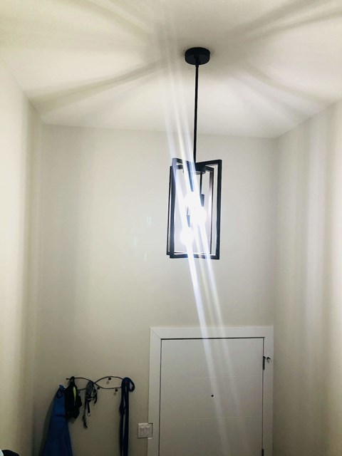 A light fixture hanging from a ceiling in a room.