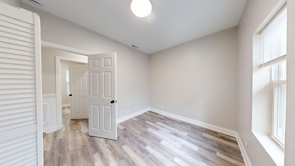 A room with a wooden floor and white walls.