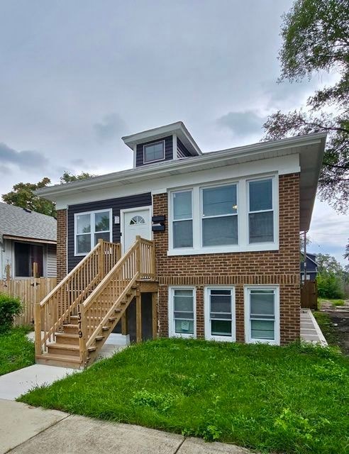 A house with a brown brick exterior and a white roof.
