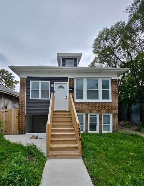 A house with a white door and a staircase leading to the entrance.