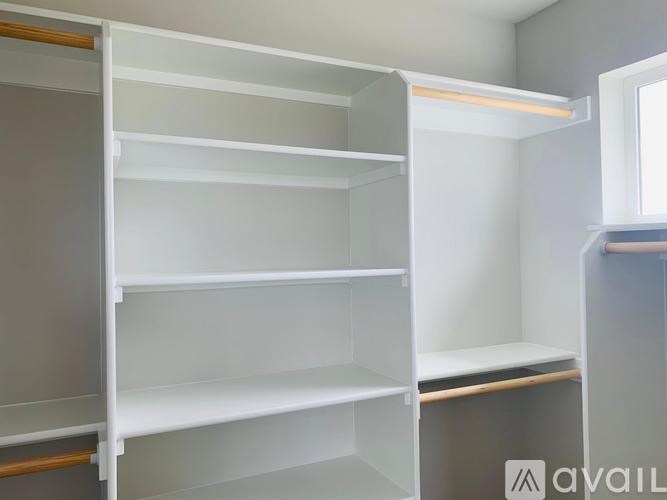 Empty white shelves in a room.