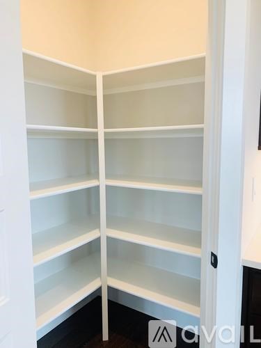 Empty white shelves in a room.