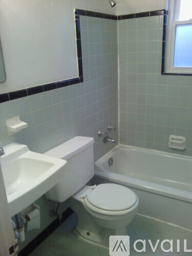 A white toilet sits next to a sink in a small bathroom.