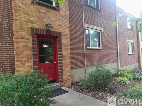 A red door with the number 5630 above it.