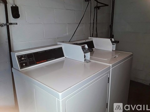 A white washing machine with a dryer on top of it.