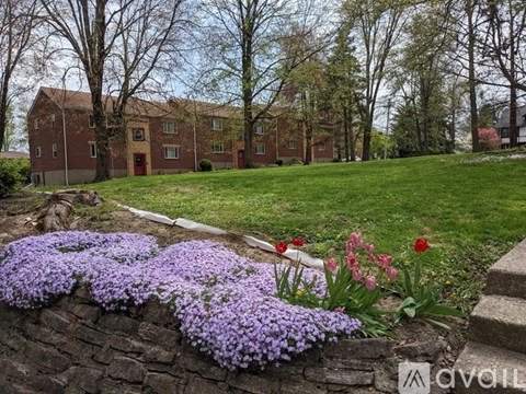 Flowers in front of a brick building.