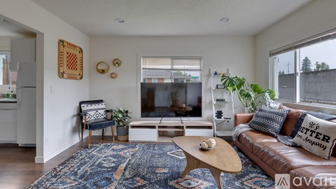 A living room with a brown leather couch and a wooden coffee table.
