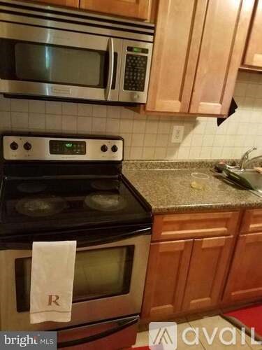 A kitchen with a stove top oven and microwave above it.