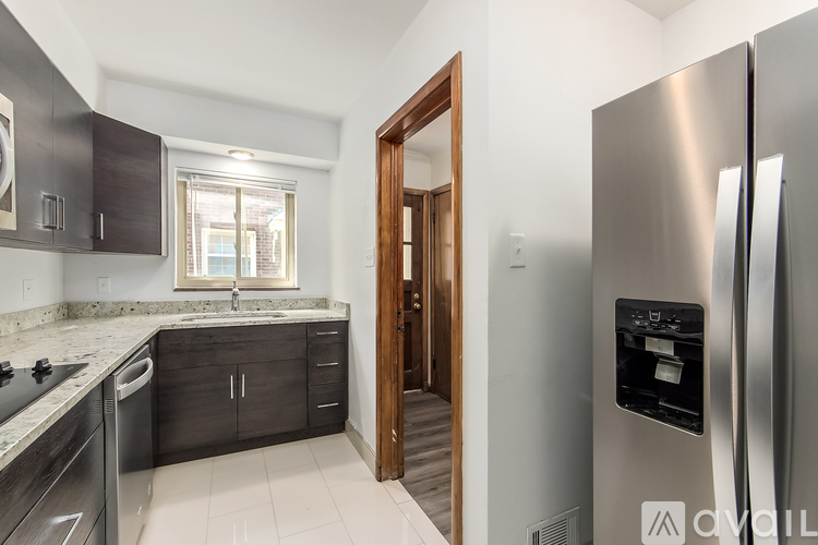 A modern kitchen with a refrigerator on the right.