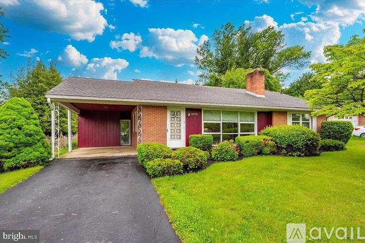 A house with a red garage door is for sale.