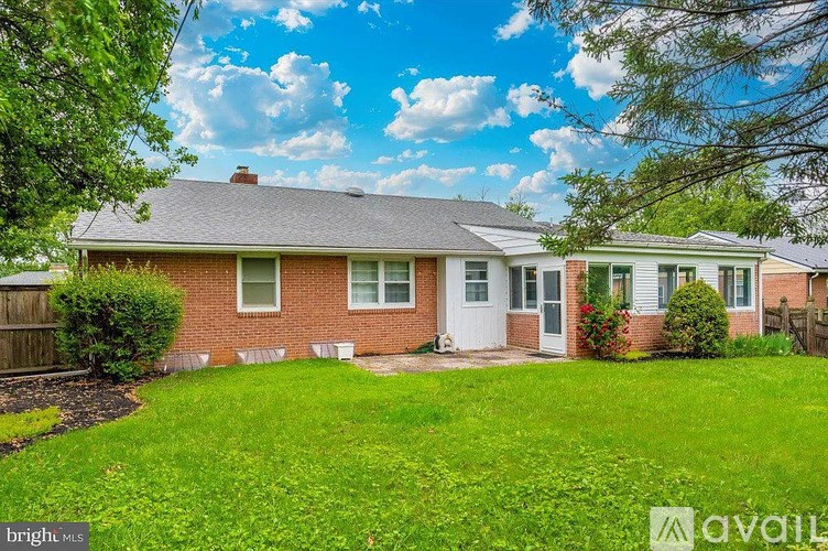 A house with a white door and a green lawn.