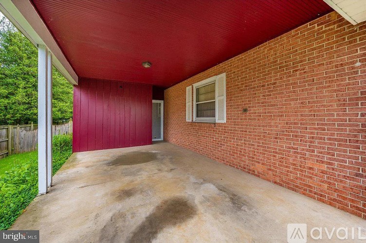 A red garage with a white door and a window.