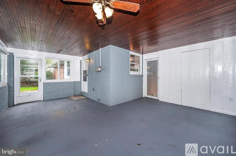 A room with a wooden ceiling and a fan.