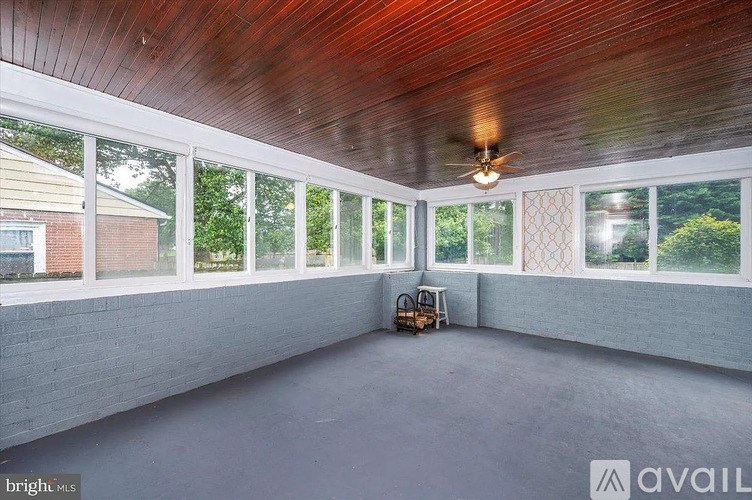 A room with a wooden ceiling and a fan.