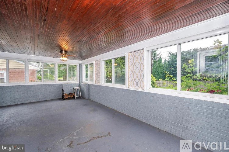 A room with a wooden ceiling and a fan.