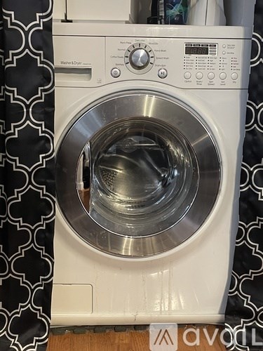 A front-loading washing machine with the door open.