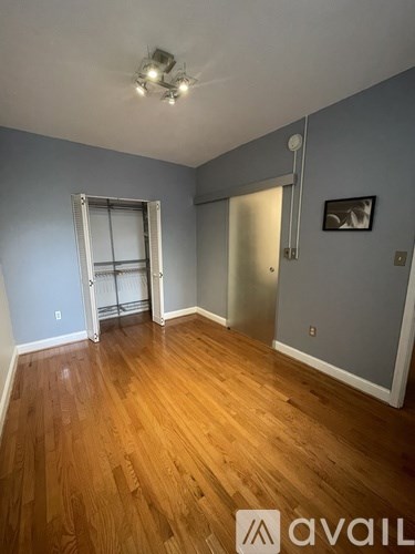 A room with wooden floors and a sliding glass door.