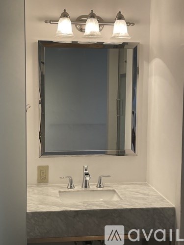 A bathroom sink with a mirror above it.
