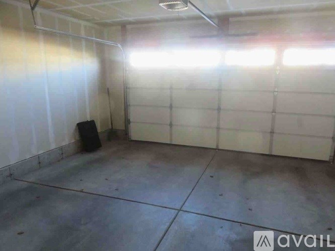 A room with a black speaker on the floor.